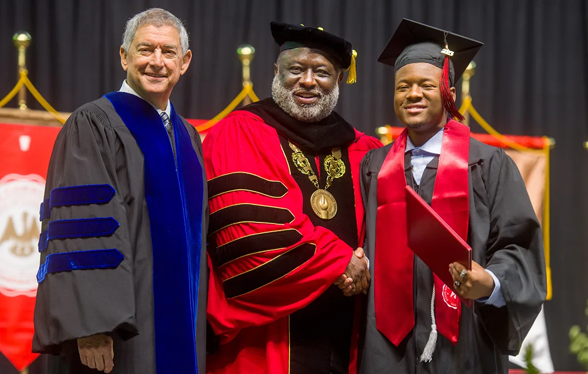  Baton Rouge Community College Chancellor Dr. Willie E. Smith and Louisiana Commissioner of Administration Jay Dardenne congratulate a graduate during BRCC’s 27th Commencement Ceremony held on Tuesday, May 25 at the Raising Canes River Center.